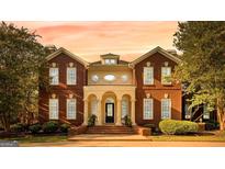 Stately brick home featuring classic architecture, arched entryway, and manicured landscaping at 1477 Highway 85 Connector, Brooks, GA 30205