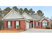 Charming brick home with black shutters, attached garage, and well-maintained front yard at 110 Cloverwood Dr, Fayetteville, GA 30215