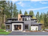 Modern home featuring clean lines, large windows, and professional landscaping for an amazing curb appeal at 200 Simonton Rd, Lawrenceville, GA 30046