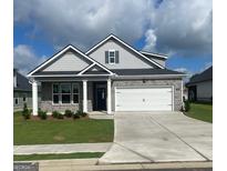 Charming one-story home featuring a gray brick facade, white garage door, and manicured lawn at 753 Myrica Ave, Locust Grove, GA 30248