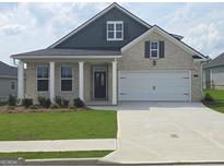 Charming brick home featuring a well-manicured lawn, covered front porch, and a two-car garage at 749 Myrica Ave # 208, Locust Grove, GA 30248