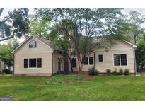 Charming single Gathering home featuring a well-manicured lawn and inviting facade at 213 W Hightower Trl, Social Circle, GA 30025