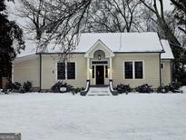 Charming craftsman home with snowy front yard and welcoming porch at 213 W Hightower Trl, Social Circle, GA 30025