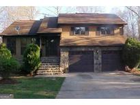 Two-story house with stone accents and a two-car garage at 2655 West Rd, Riverdale, GA 30296