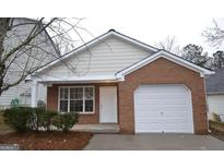 Brick ranch home with a white garage door at 6627 Coventry Pt, Austell, GA 30168