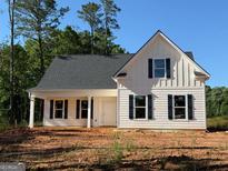 Charming new construction home with board and batten siding, black shutters, and covered front porch at 136 Asa Moseley Rd, Mcdonough, GA 30252