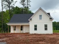 New construction home with white siding, black roof, and inviting front porch, ready for landscaping at 136 Asa Moseley Rd, Mcdonough, GA 30252