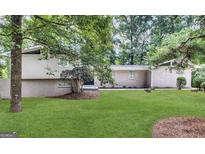 Ranch style home with a large yard and mature trees at 5515 Saint Lo Ln, College Park, GA 30349