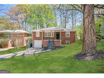Brick ranch home with a spacious yard and attached garage at 211 Hemphill School Rd, Atlanta, GA 30331