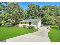 Ranch style home with a large yard and driveway at 3961 Cornell Sw Blvd, Atlanta, GA 30331