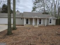 Ranch style home with attached garage and mature trees at 471 Glen Terrace Rd, Auburn, GA 30011