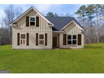 Charming single-Gathering home with a well-manicured lawn at 115 Oak Road, Locust Grove, GA 30248