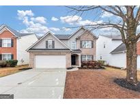 Two-story house with gray siding, attached garage, and landscaping at 2114 Black Oak Ln, Ellenwood, GA 30294