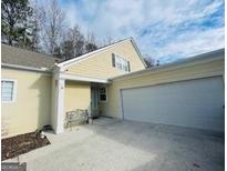 Inviting exterior featuring a two-car garage and charming front porch at 144 Cottsford Sw Dr # 22, South Fulton, GA 30331