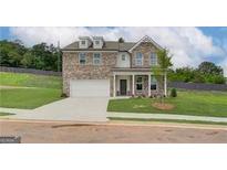 Charming two-story brick home with well-manicured lawn and inviting covered porch at 376 Collier Mills Road, Lawrenceville, GA 30045