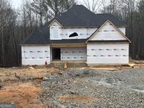 New house exterior with gray roofing and house wrap still installed at 214 Wet Wood Ct # 26, Fairburn, GA 30213