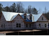 New construction home features ProLinx building wrap and three dormer windows at 2113 Ella Springs Dr, Covington, GA 30014