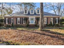 Brick home with a charming front porch and landscaping at 203 Savannah Walk, Peachtree City, GA 30269