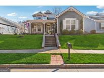 Charming two-story house with a wrap-around porch and well-manicured lawn at 507 Lake Front Dr, Canton, GA 30115