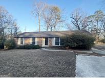 Brick ranch house with a spacious yard and mature trees at 6796 Black Twig Ct, Riverdale, GA 30274