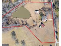 Expansive property featuring a large pond, barns, and a charming farmhouse surrounded by picturesque landscapes at 444 Agape Rd, Carrollton, GA 30116