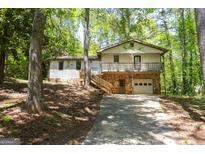 Charming split-level home featuring a stone facade and a welcoming front porch at 60 Sweet Bay Ln, Carrollton, GA 30116