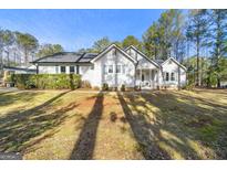 Ranch style home with a spacious yard and mature trees at 10 Oxford Pl, Sharpsburg, GA 30277