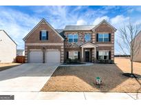 Brick two-story house with a two-car garage and landscaped yard at 234 Loganview Dr, Loganville, GA 30052