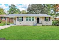 Updated ranch home with a well-manicured lawn at 2284 Headland Dr, East Point, GA 30344