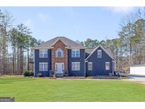 Two-story house with stone accents and a large grassy yard at 5479 Dukes Rd, Douglasville, GA 30135