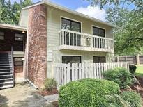 Two-story condo with balcony, white picket fence, and landscaping at 738 Brentwood Pl, Marietta, GA 30067