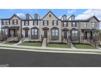 Charming brick townhomes featuring a modern design and well-maintained landscaping at 2070 Fortuna St, Lawrenceville, GA 30046