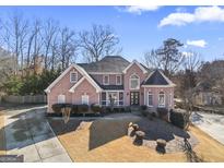 Brick house with a large front yard and driveway at 295 Camden Creek Ct, Lawrenceville, GA 30043