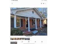 Brick ranch house with covered porch and columns at 6045 Winview Dr, Forest Park, GA 30297