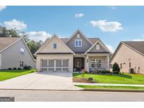 Brick front two-story house with three-car garage and landscaped lawn at 320 Timberview Cir, Sharpsburg, GA 30277