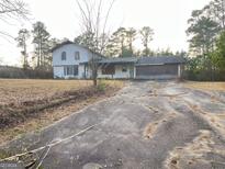 Two-story house with a large yard and driveway at 1283 Corley Nw Rd, Conyers, GA 30012