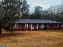 Brick ranch house with mature landscaping and a large yard at 500 Circle Dr, Fayetteville, GA 30214