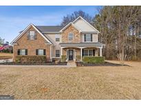 Brick two-story house with stone accents, landscaping, and a large front yard at 304 Mary Dr, Mcdonough, GA 30252