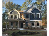 Two-story house with brick and blue siding, landscaping, and a front porch at 4537 Ajo Walk, Atlanta, GA 30331