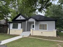 Charming home with grey siding, black roof, and inviting front porch at 1771 Ware Ave, East Point, GA 30344