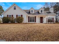 White house with maroon accents and a well-maintained lawn at 500 Wyntuck Dr, Mcdonough, GA 30253