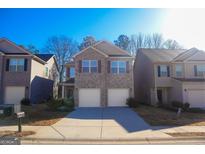 Two-story brick home with two-car garage and landscaping at 11958 Quail Dr, Hampton, GA 30228