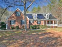 Brick home with solar panels, landscaping, and a large front yard at 265 Whitaker Rd, Mcdonough, GA 30252