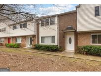 Brick townhouse exterior with landscaping and walkway at 7122 Stonington Dr, Sandy Springs, GA 30328