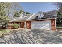 Lovely brick home with a large garage and dormer windows at 25 Brookstone Ct, Covington, GA 30016
