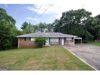 Brick ranch home with carport and large yard at 1145 Crestview Ne Cir, Conyers, GA 30012