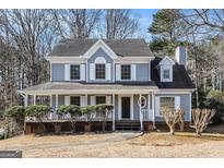 Two-story house with gray siding, white trim, and a covered porch at 2671 Eastmont Trl, Snellville, GA 30039