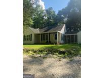 Charming one-story house with a spacious front yard and mature trees at 1178 King Rd, Riverdale, GA 30296