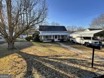 Charming house with a front yard and screened porch at 1603 Elm Ne St, Conyers, GA 30012