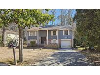 Ranch style home with gray siding, brick accents, and a two-car garage at 6665 Cedar Hurst Trl, College Park, GA 30349